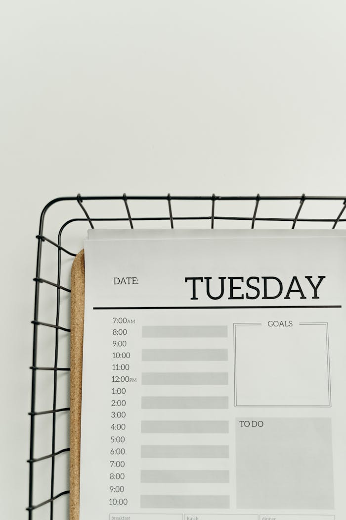 A minimalist planner displaying a Tuesday schedule with time slots, goals, and to-do sections.